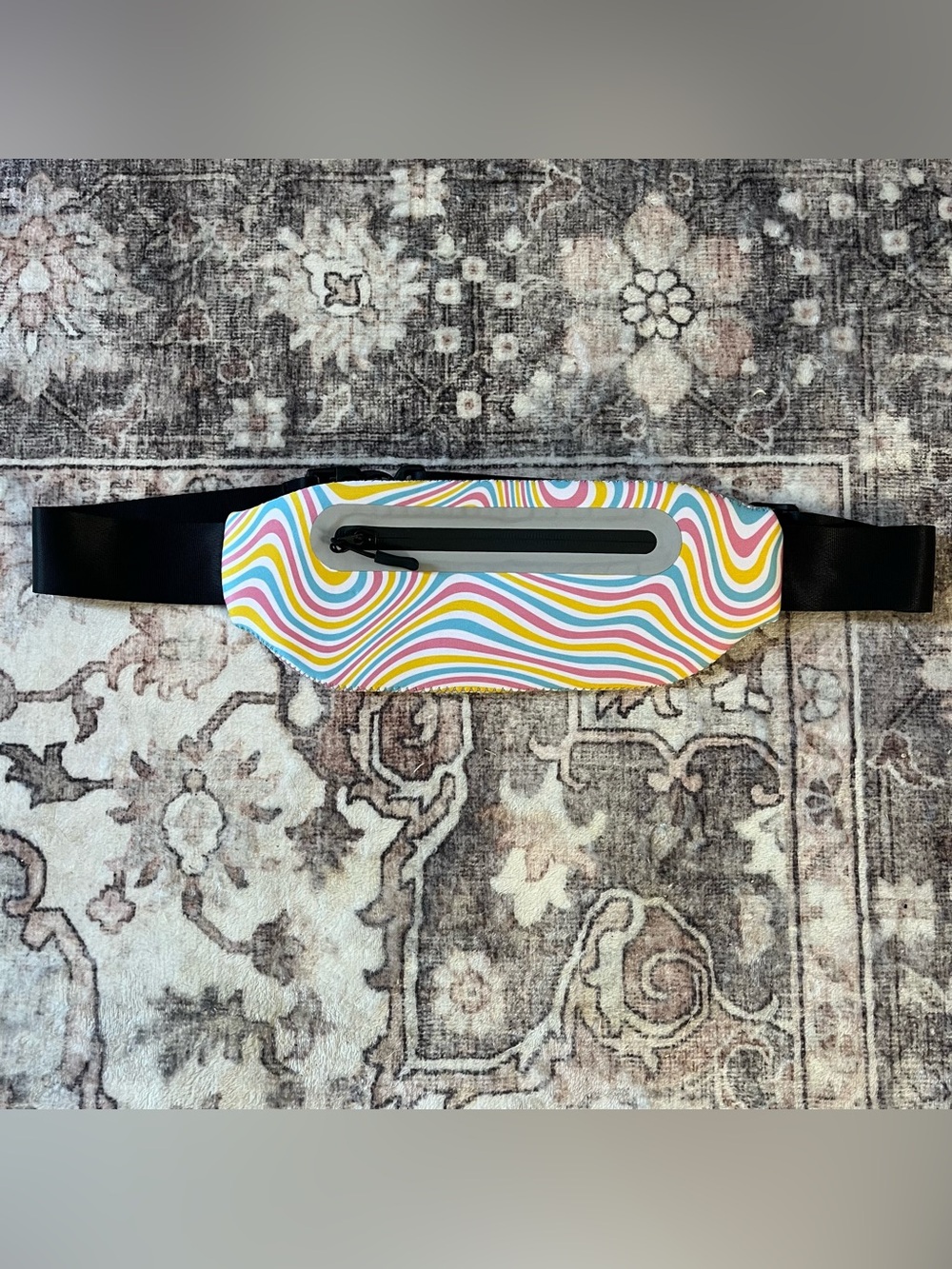 Running pouch in vibrant, swirling, multi-colored pattern